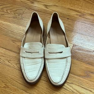 Cream-colored point-toed loafers